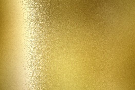 Glowing gold metallic wall, abstract texture background