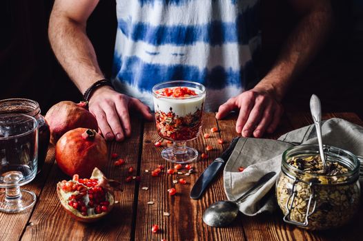 Cooked Dessert with Ingredients. Series on Prepare Healthy Dessert with Pomegranate, Granola, Cream and Jam