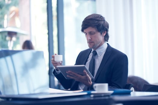 Business man with tablet computer in cafe