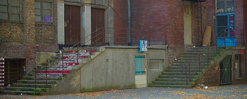 Two concrete stairways on a rustic urban building