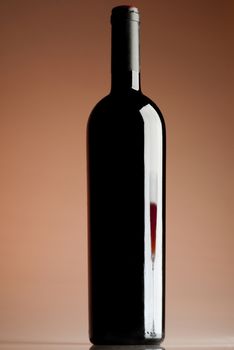 Bottle of wine, reflection of a glass of wine, red wine