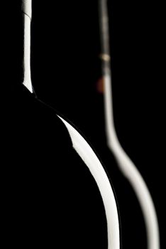 Silhouette of wine bottle, black background, two bottles of wine