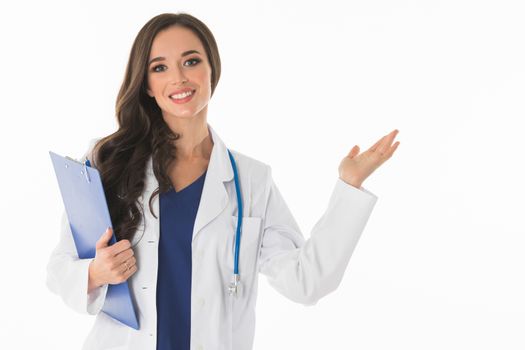 Happy smiling young beautiful female doctor showing blank area for sign or copyspace , isolated over white background