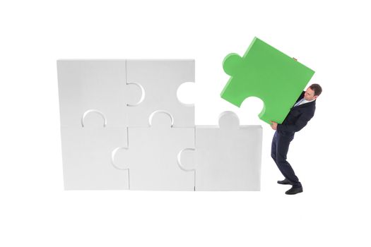 Business man assembling puzzle of giant pieces . Strategy and problem solution concept