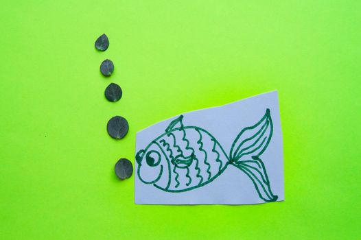 Funny fish with bubbles on green background, fool's Day.