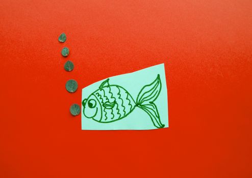 Funny fish with bubbles on red background, fool's Day.