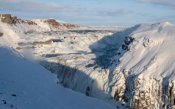 Panoramic image of the frozen waterfall Gullfoss, Iceland, Europe