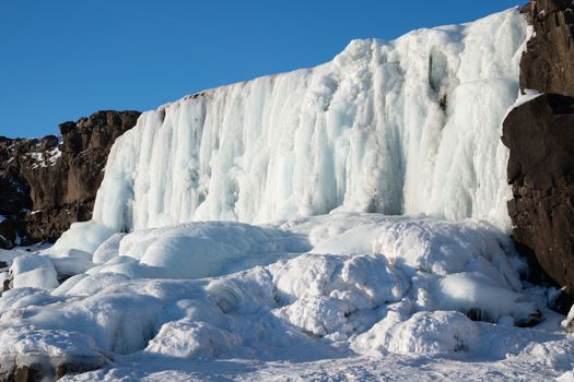 Frozen waterfall Oexararfoss within the Thingvellir National Park, Iceland, Europe