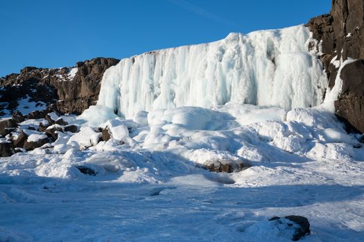 Frozen waterfall Oexararfoss within the Thingvellir National Park, Iceland, Europe