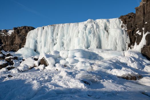Frozen waterfall Oexararfoss within the Thingvellir National Park, Iceland, Europe