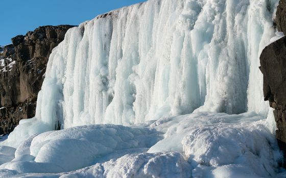 Frozen waterfall Oexararfoss within the Thingvellir National Park, Iceland, Europe