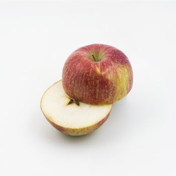 an apple cut on a white surface