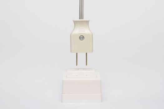 AC power plug with electrical cable on white background.