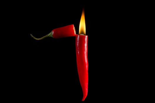 Fire of chili, Hot chili lighter on dark background.