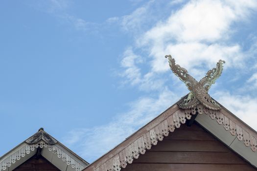 Gable roof house in Thai style and White clouds and beautiful clear sky.