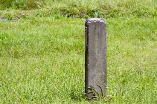 Concrete pile on the green grass of the grass.