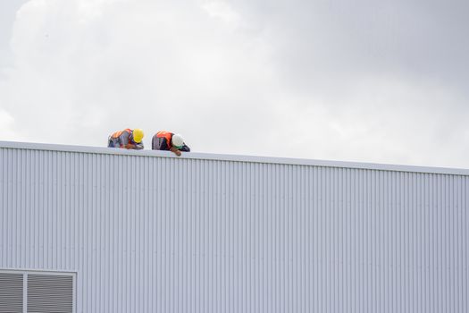 Construction workers on the roof of the building.