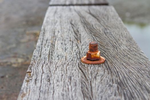 The nut is rust on old wood floor.