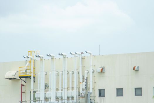 Several white ventilation vents are located next to the building.