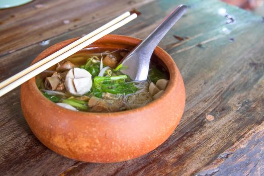 Clay pot rice noodles put on a wooden table