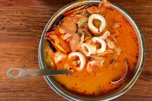 Tom Yum Goong put on a wooden table top view 