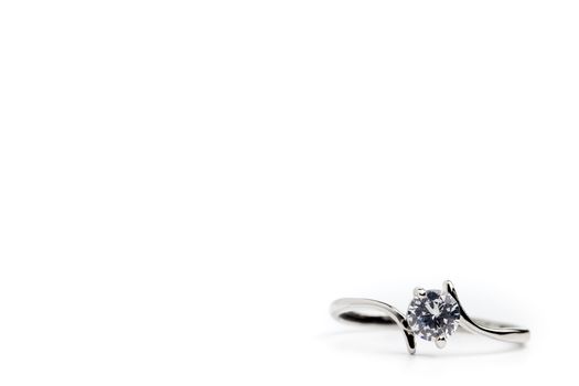 Fake diamond ring placed on a white background. The concept of love or marriage. Copy space can be used to write articles about Valentine's Day.