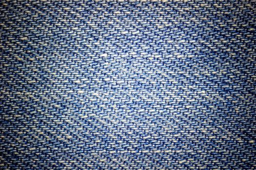 Closeup texture of blue jeans. Suitable for making backgrounds, vintage or retro articles.