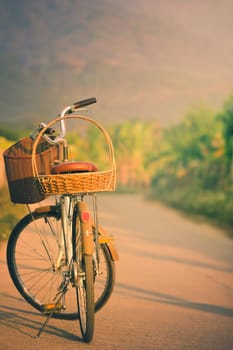 Bicycle on the side of the road way with mountains background. Copy space for text or article.