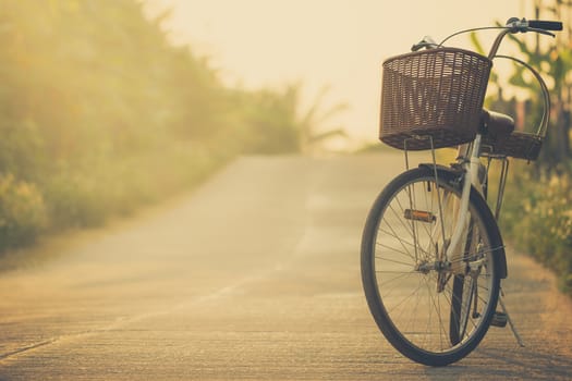 Bicycle on the side of the road way with mountains background. Copy space for text or article.