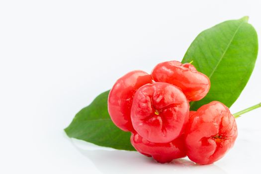 Closeup fresh rose apple with water droplet and leaves on white background.