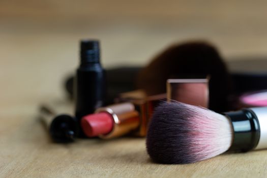 Cosmetics put on a brown wood table. Suitable for backgrounds, articles about women's beauty.