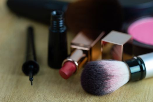 Cosmetics put on a brown wood table. Suitable for backgrounds, articles about women's beauty.