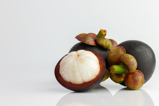 Three of the mangosteen were peeled off on a white background.