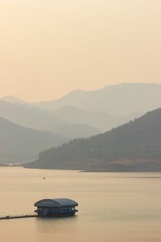 Raft floating on the middle of a dam or lake in the evening.