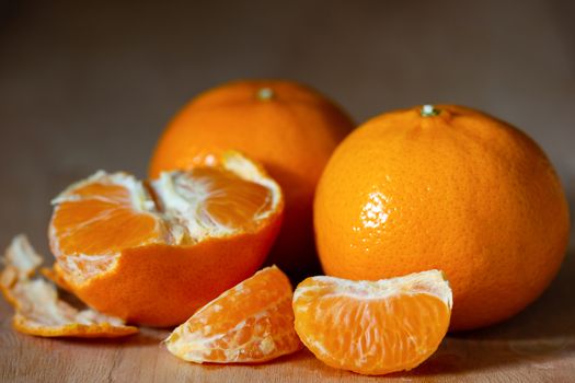 Tangerine peeled on a wooden table. The concept of love and health care.