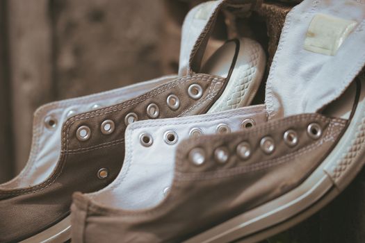 Old sneakers put on a piece of cement in the hot sun.