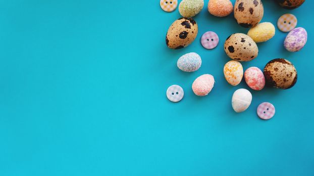 Quail Easter eggs on blue background. Flat lay, top view. Easter concept banner.