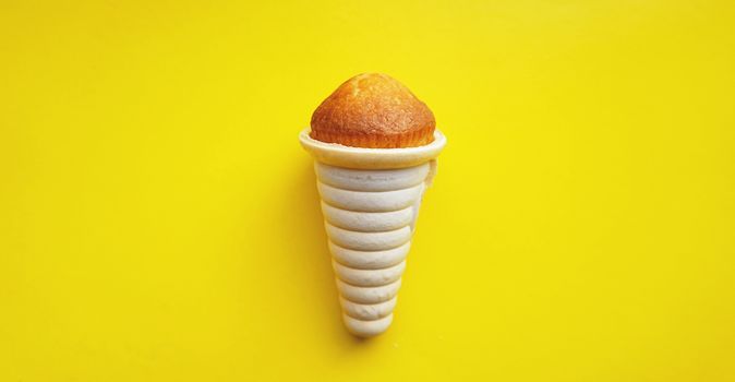 Icecream waffle cone and cupcake isolated on yellow background