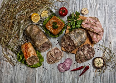 Ham and vegetables on an old wooden background