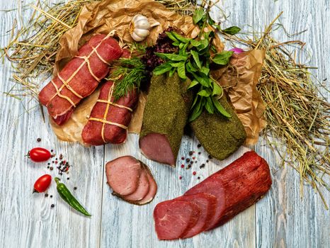 Ham and vegetables on an old wooden background