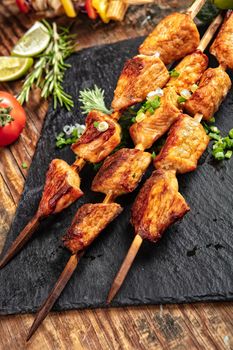 Shaslik and vegetables on a wooden table