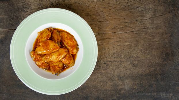 Baked chicken wings with spicy sauce. Food background with copy space. Top view