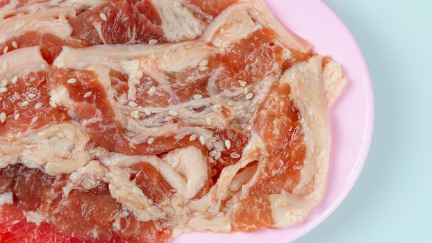 top view raw pork on plate  over white background