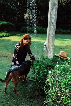 Asian woman washing her pet dog