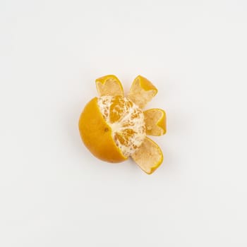 a tangerine peeled on a white surface