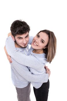 Young couple in blue hugging isolated on white