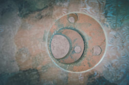 Holes made in a metallic table create this circle pattern on the rusty surface in San Pedro de Atacama, Chile