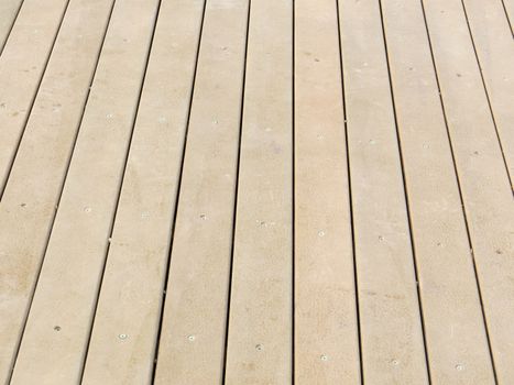 Detail of wooden floorboards in perspective vertical, on clear day.