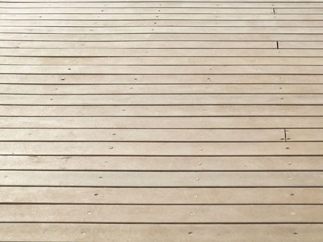 Detail of background, wooden floor screwed horizontally. Outside area on a clear day.