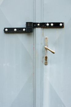 picture of locked hasp on grey metal gate - Image. Front view on locked garage gate.